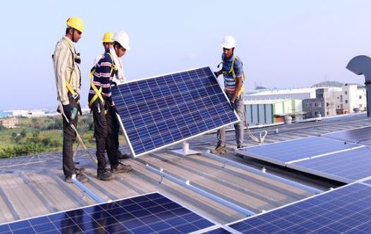 Netcco technicians installing rooftop solar panels